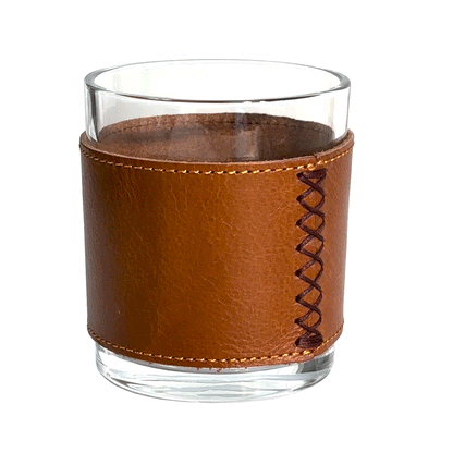 Rotating brown leather wrapped rocks glass with a crystalline finish