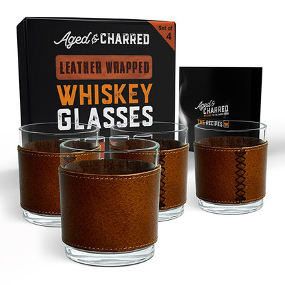 A set of four brown leather wrapped rocks glasses with a crystalline finish packaged in a gift-ready box including top cocktail recipes