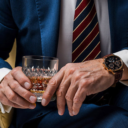 Businessman holding whiskey glass