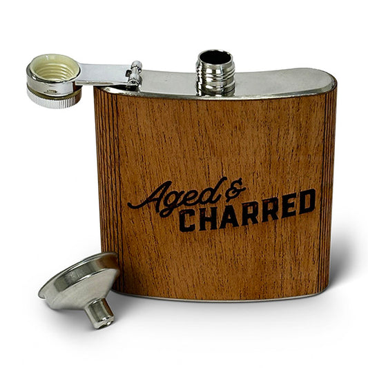 A 6oz stainless steel flask with a mahogany wood finish, including a funnel and leak-proof cap, displaying the text 'AGED & CHARRED' on the front.